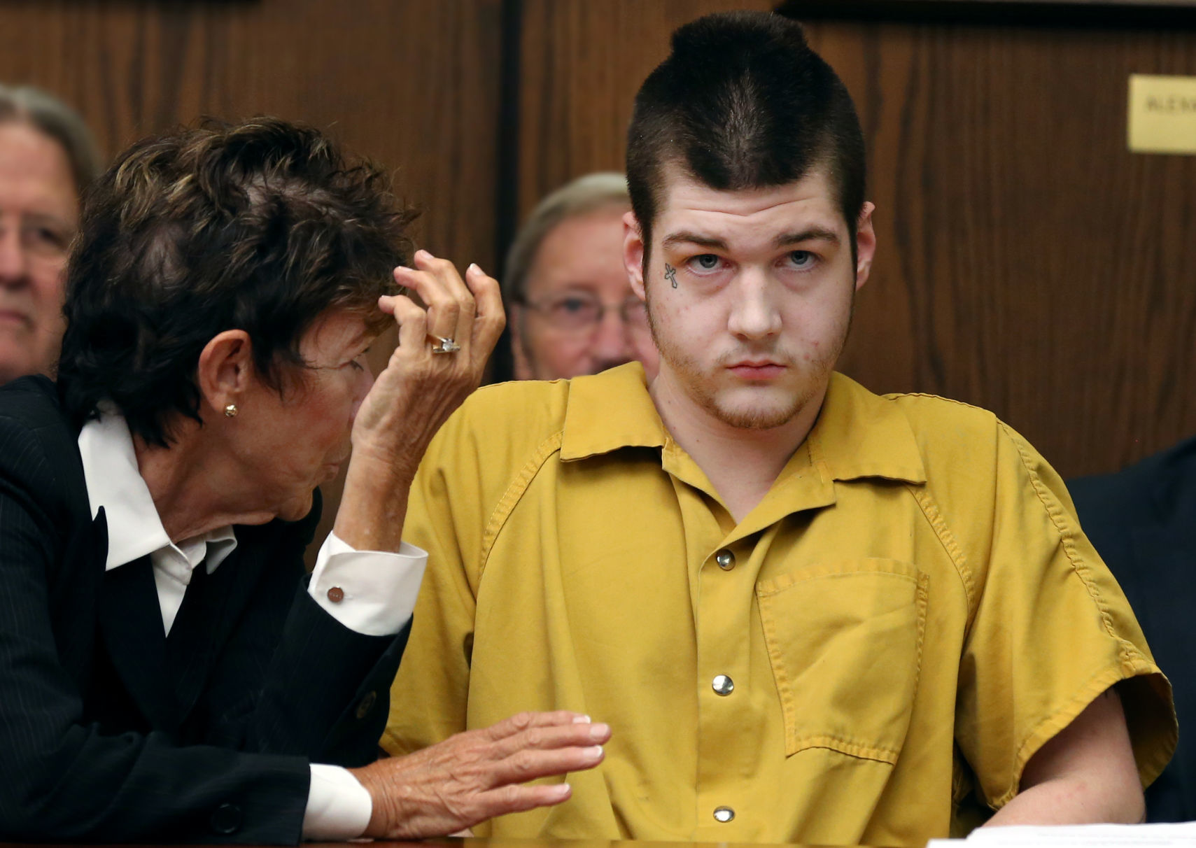 Trevor E. Charles listens to defense attorney Deborah Caldwell-Bono